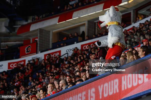 Harvey the Hound, of the Calgary Flames cheers the fans in an NHL game against the Minnesota Wild at the Scotiabank Saddledome on October 21, 2017 in...