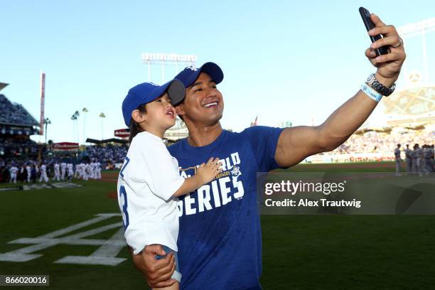 Actor Mario Lopez takes a selfie on the field prior to Game 1 of the 2017 World Series between the Houston Astros and the Los Angeles Dodgers at...