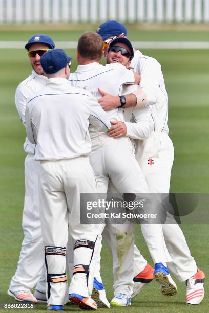 Neil Broom of Otago is congratulated by team mates after dismissing Cameron Fletcher of Canterbury during the Plunket Shield match between Canterbury...