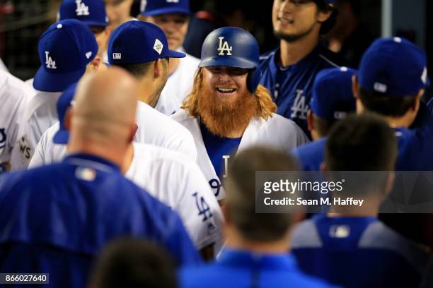 Justin Turner of the Los Angeles Dodgers celebrates with teammates in the dugout after hitting a two-run home run during the sixth inning against the...