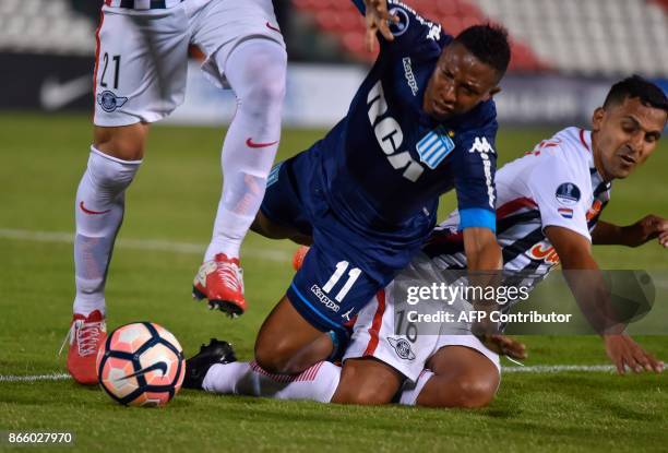 Argentina's Racing Andres Ibarguan and Paraguay's Libertad Sergio Aquino fall as they vie for the ball during their Sudamericana Cup quarterfinal...