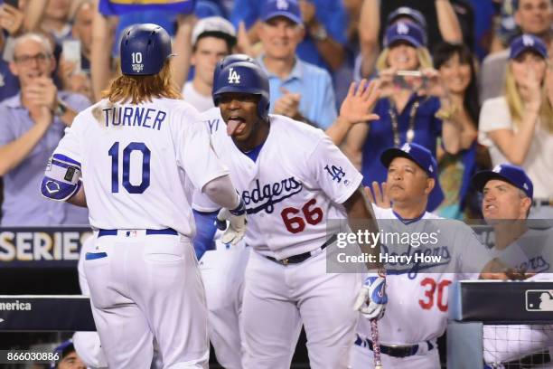 Justin Turner of the Los Angeles Dodgers celebrates with Yasiel Puig after hitting a two-run home run during the sixth inning against the Houston...