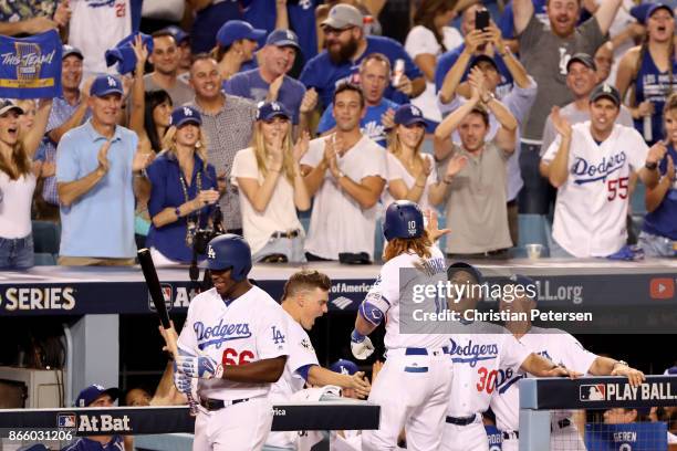 Justin Turner of the Los Angeles Dodgers celebrates with manager Dave Roberts after hitting a two-run home run during the sixth inning against the...
