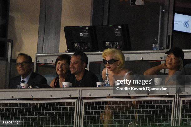 Singer-songwriter Lady Gaga and MLB chief baseball officer Joe Torre attend game one of the 2017 World Series between the Houston Astros and the Los...