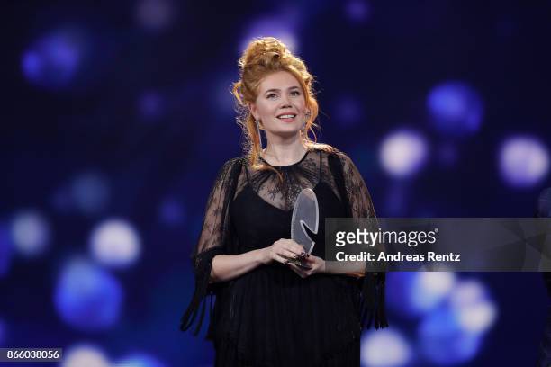 Palina Rojinski holds her award for 'Best Cinema Comedy' during the 21st Annual German Comedy Awards on October 24, 2017 in Cologne, Germany