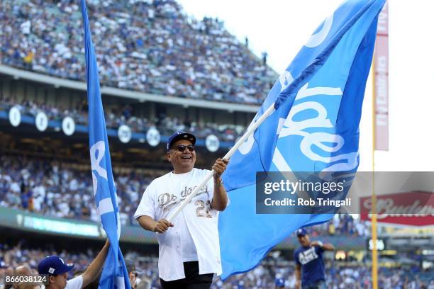 Actor George Lopez waves a Dodger flag on top of the dugout prior to Game 1 of the 2017 World Series between the Houston Astros and the Los Angeles...