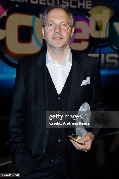 Olli Dittrich poses with his award as 'Best Actor' during the 21st Annual German Comedy Awards on October 24, 2017 in Cologne, Germany