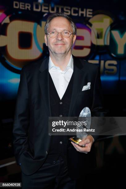 Olli Dittrich poses with his award as 'Best Actor' during the 21st Annual German Comedy Awards on October 24, 2017 in Cologne, Germany