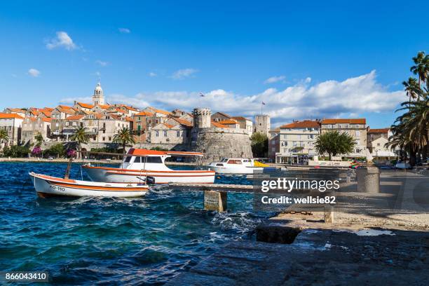 boats bob on the choppy waters by korcula old town - コルチュラ島 ストックフォトと画像