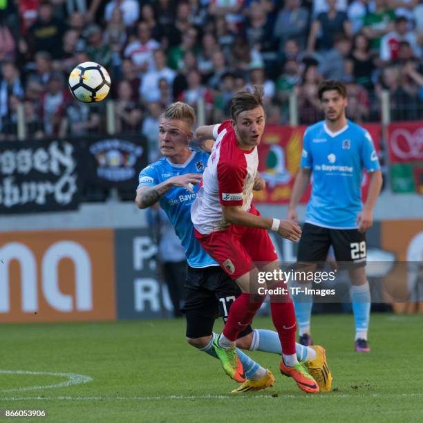 Daniel Wein of 1860 Muenchen and Lukas Ramser of Augsburg battle for the ball during the Regionalliga Bayern match between FC Augsburg II and 1860...