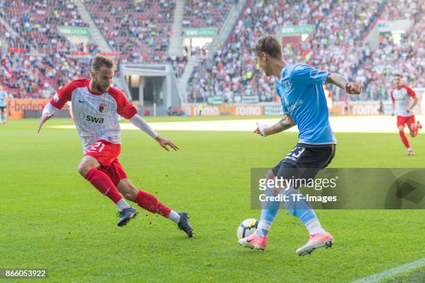 Nicola Della Schiava of Augsburg and Nicholas Helmbrecht of 1860 Muenchen battle for the ball during the Regionalliga Bayern match between FC...