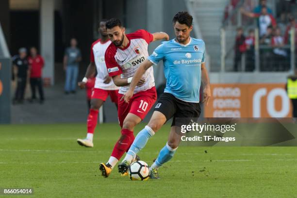 Efkan Bekiroglu of Augsburg and Aaron Berzel of 1860 Muenchen battle for the ball during the Regionalliga Bayern match between FC Augsburg II and...