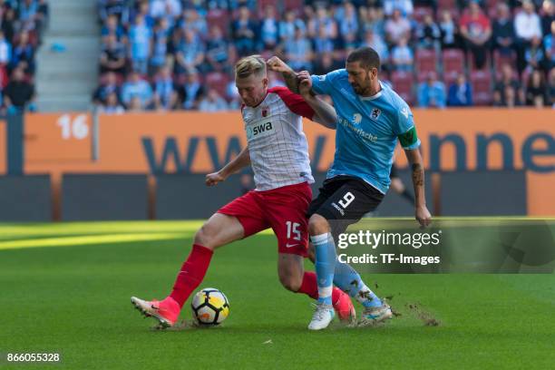 Jan-Ingwer Callsen-Bracker of Augsburg and Sascha Mölders of 1860 Muenchen battle for the ball during the Regionalliga Bayern match between FC...