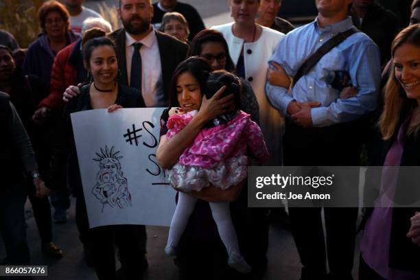 Sandra Lopez-Munoz of Silt, CO, and her daughter Areli Gonzalez-Lopez almost 2, are welcomed into sanctuary with the Two Rivers Unitarian...