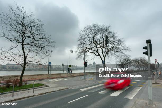 budapest street scene with the hungarian parliament in the background - budapest winter stock pictures, royalty-free photos & images