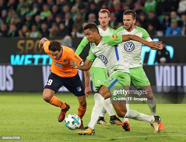 Mark Uth of Hoffenheim and Maximilian Arnold of Wolfsburg , Ohis Felix Uduokhai of Wolfsburg and Ignacio Camacho of Wolfsburg battle for the ball...