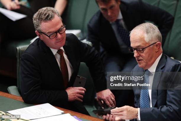 Minister for Defence Industry Christopher Pyne speaks with Prime Minister Malcolm Turnbull during House of Representatives question time at...