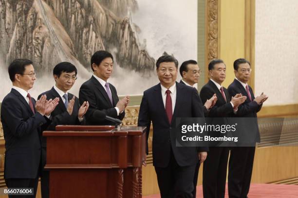 Xi Jinping, China's president and general secretary of the Communist Party of China, center, approaches the podium as other members of the Communist...
