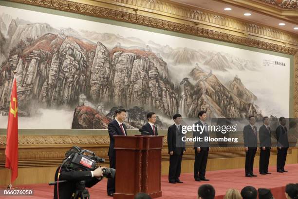 Xi Jinping, China's president and general secretary of the Communist Party of China, from left, stands at the podium as other members of the...