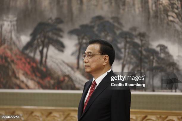 Li Keqiang, China's premier and member of the Communist Party of China's new Politburo Standing Committee, stands on stage during its unveiling in...