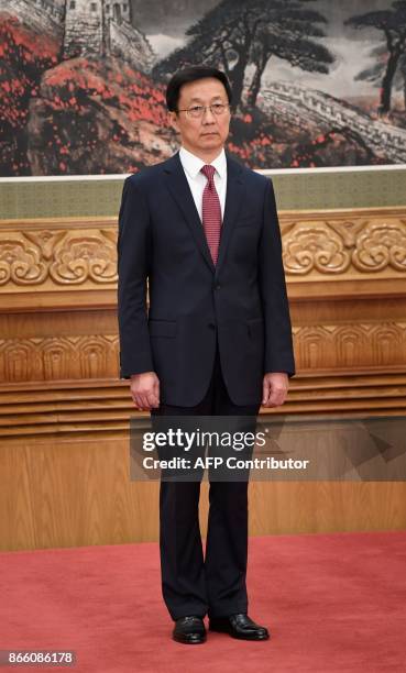 Han Zheng, Secretary of the Shanghai Municipal Party Committee, stands as he is introduced as a new member of the Communist Party of China's...