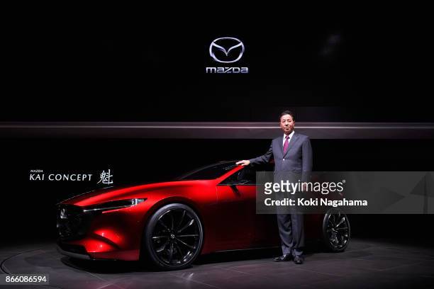 Mazda Motor Co CEO Masamichi Kogai poses with Mazda Kai Concept during a press conference at the Mazda Motor Co booth during the Tokyo Motor Show at...