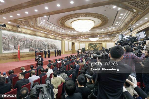 Members of the media observe as Xi Jinping, China's president and general secretary of the Communist Party of China, on stage from left, speaks at...