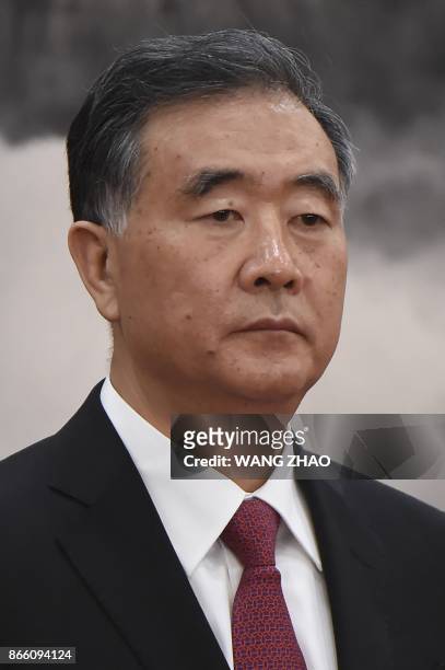 Chinese Vice Premier Wang Yang stands as he is introduced as a new member of the Communist Party of China's Politburo Standing Committee, the...