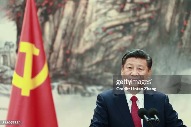 Chinese President Xi Jinping speaks at the podium during the unveiling of the Communist Party's new Politburo Standing Committee at the Great Hall of...