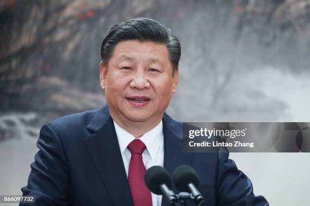 Chinese President Xi Jinping speaks at the podium during the unveiling of the Communist Party's new Politburo Standing Committee at the Great Hall of...