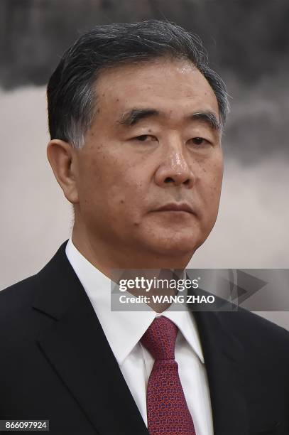 Chinese Vice Premier Wang Yang stands as he is introduced as a new member of the Communist Party of China's Politburo Standing Committee, the...