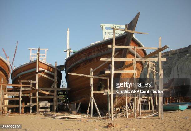 In this photograph taken on October 4 Pakistani fishermen construct a boat in Gwadar port. Remote and impoverished, Pakistan's Gwadar port at first...