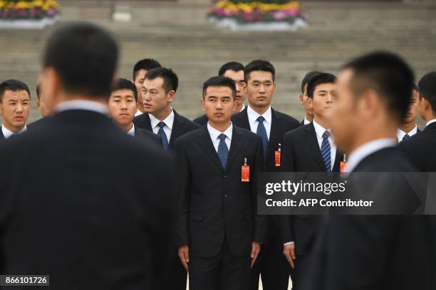 Chinese soldiers dressed in suits wait outside the Great Hall of the People in Beijing, after the introduction of the Communist Party of China's...