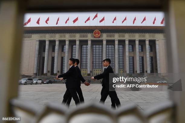 Chinese soldiers dressed in suits march outside the Great Hall of the People in Beijing, before the introduction of the Communist Party of China's...