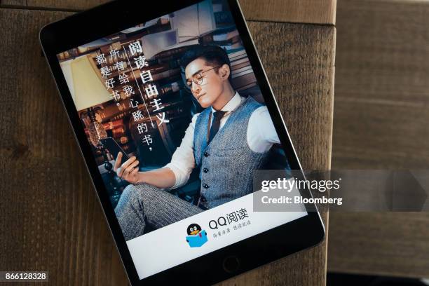 Welcome screen for the QQ Reading application, operated by China Literature Ltd., a unit of Tencent Holdings Ltd., is displayed on an Apple Inc. IPad...
