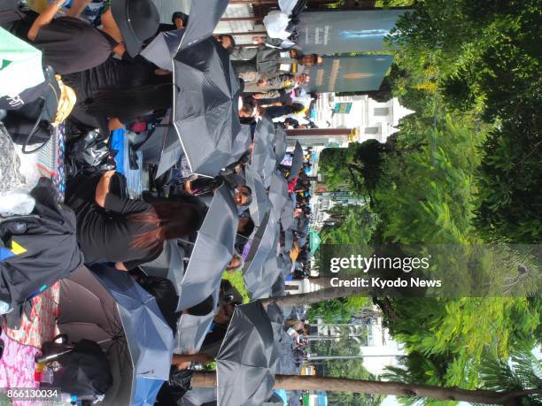 Huge crowds of mourners camp out along the royal funeral route in the Rattanakosin areas in Bangkok on Oct. 25 ahead of the royal funeral procession...