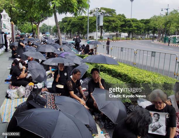 Huge crowds of mourners camp out along the royal funeral route in the Rattanakosin areas in Bangkok on Oct. 25 ahead of the royal funeral procession...