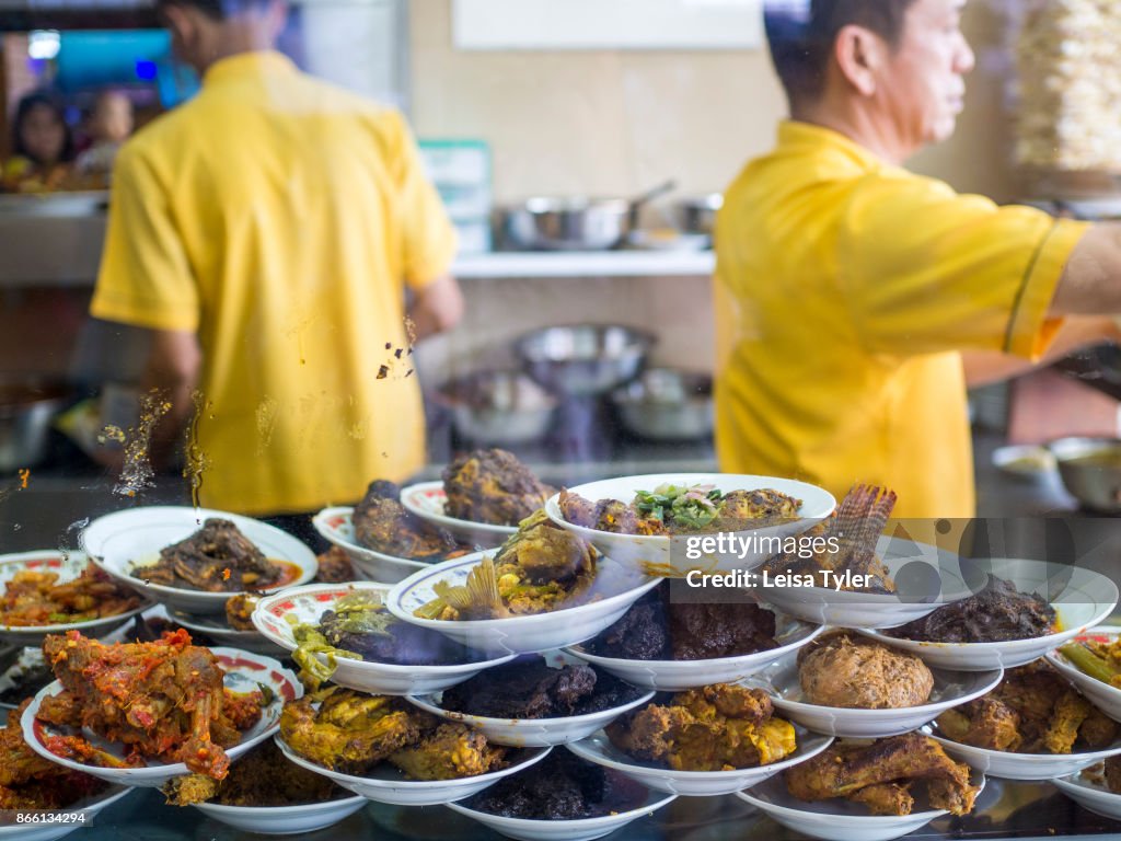 A variety of Nasi Padang dishes at at Simpang Raya in...