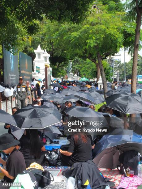 Huge crowds of mourners camp out along the royal funeral route in the Rattanakosin areas in Bangkok on Oct. 25 ahead of the royal funeral procession...