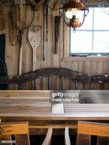 Dining table inside Everts Sjöbods, a 19th century boathouse in Grebbestad, West Sweden which is used to run a small travel business offering oyster...