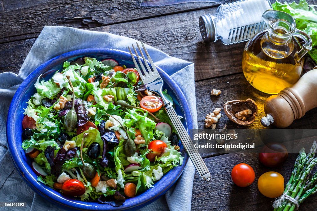 Fresh salad plate on rustic wooden table