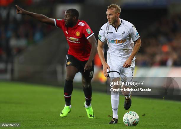 Mike van der Hoorn of Swansea City is tracked by Romelu Lukaku of Manchester United during the Carabao Cup fourth round match between Swansea City...