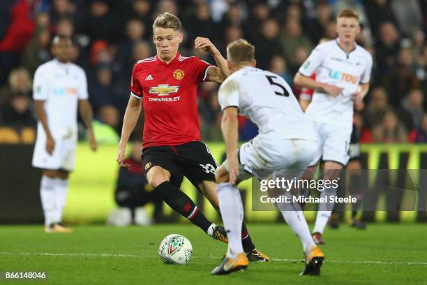 Scott McTominay of Manchester United runs at Mike van der Hoorn of Swansea City during the Carabao Cup fourth round match between Swansea City and...