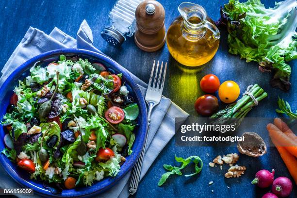 fresh salad plate on bluish kitchen table - condiment stock pictures, royalty-free photos & images