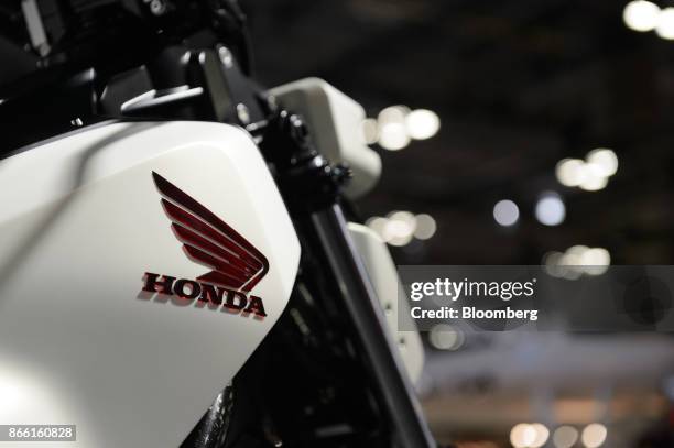 Honda Motor Co. Badge is displayed on a Honda Riding Assist-e motorcycle at the Tokyo Motor Show in Tokyo, Japan, on Wednesday, Oct. 25, 2017....