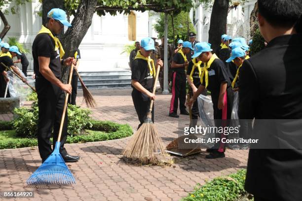 This picture by Thailand's Dailynews shows Prince Dipangkorn Rasmijoti helping to sweep a sidewalk in Bangkok on October 25 near the site of where...