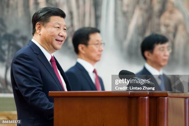 Chinese President Xi Jinping speaks at the podium during the unveiling of the Communist Party's new Politburo Standing Committee at the Great Hall of...