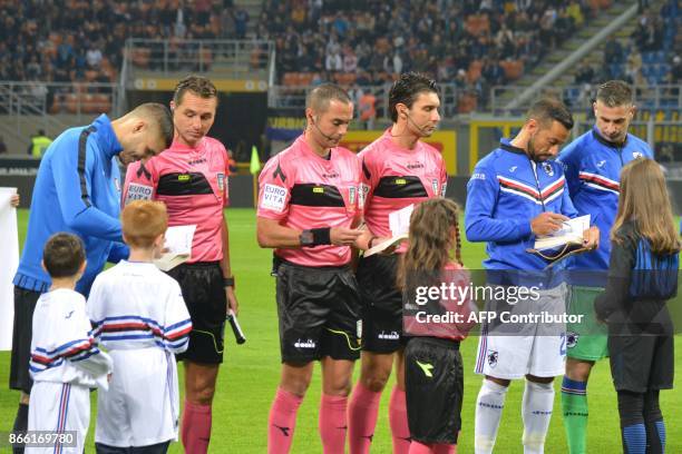 Inter Milan captain Mauro Icardi , Sampdoria counterpart Fabio Quagliarella and referee Marco Guida sign copies of "The Diary of Anne Frank" and...