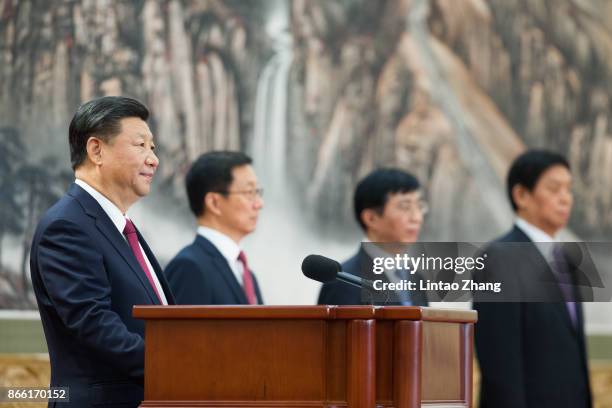 Chinese President Xi Jinping speaks at the podium during the unveiling of the Communist Party's new Politburo Standing Committee at the Great Hall of...