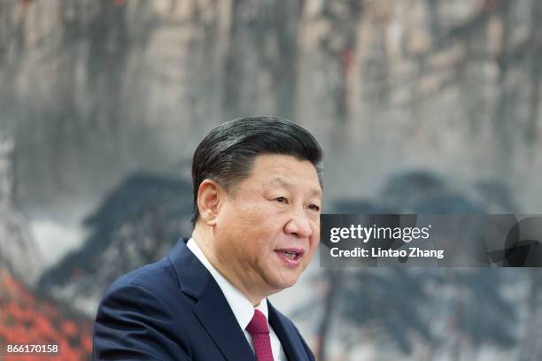 Chinese President Xi Jinping speaks at the podium during the unveiling of the Communist Party's new Politburo Standing Committee at the Great Hall of...